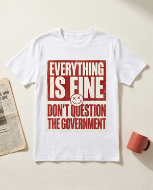Everything Is Fine sarcastic propaganda graphic tee, flat-lay on bone background
