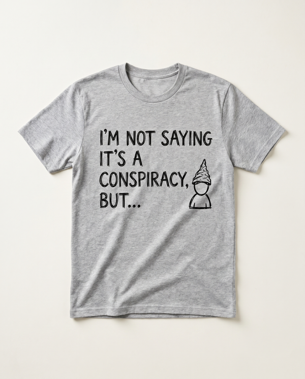 Not Saying Its A Conspiracy But tinfoil-hat doodle tee, flat-lay on bone background